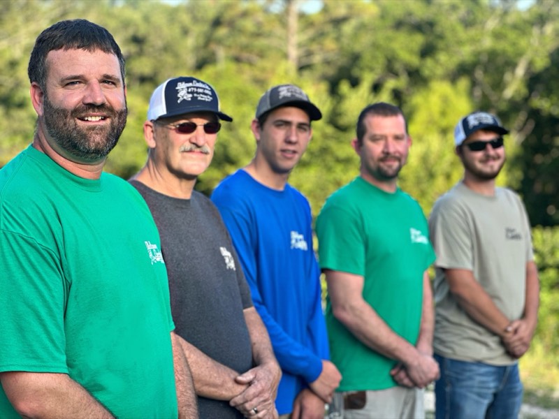 The Old Town Electric team - five electricians lined up at golden hour in Eureka Springs